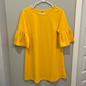 Bright yellow dress that sits above the knees with elbow length sleeves.